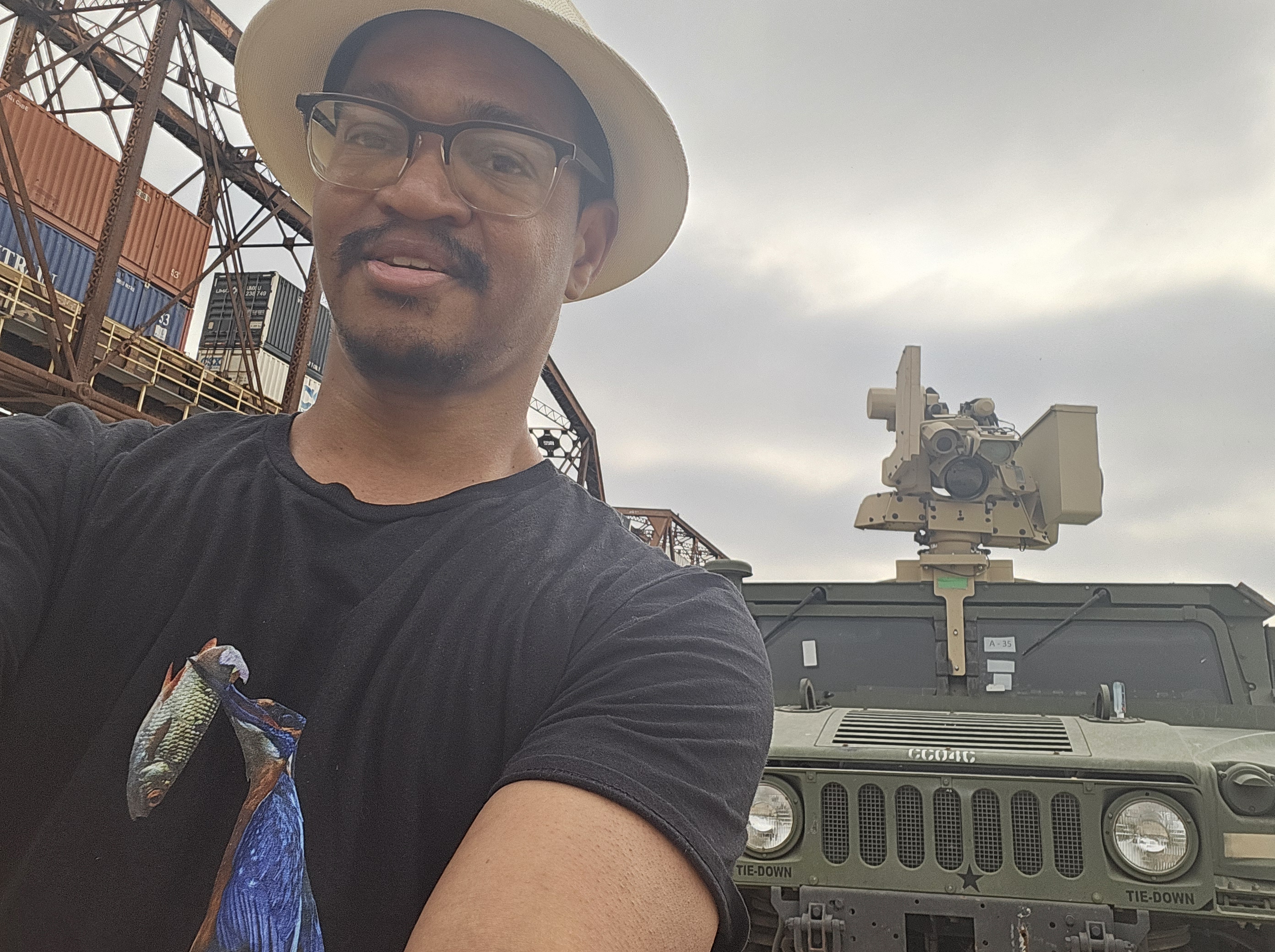 Andre Barnes in front of armored vehicle; Texas border.